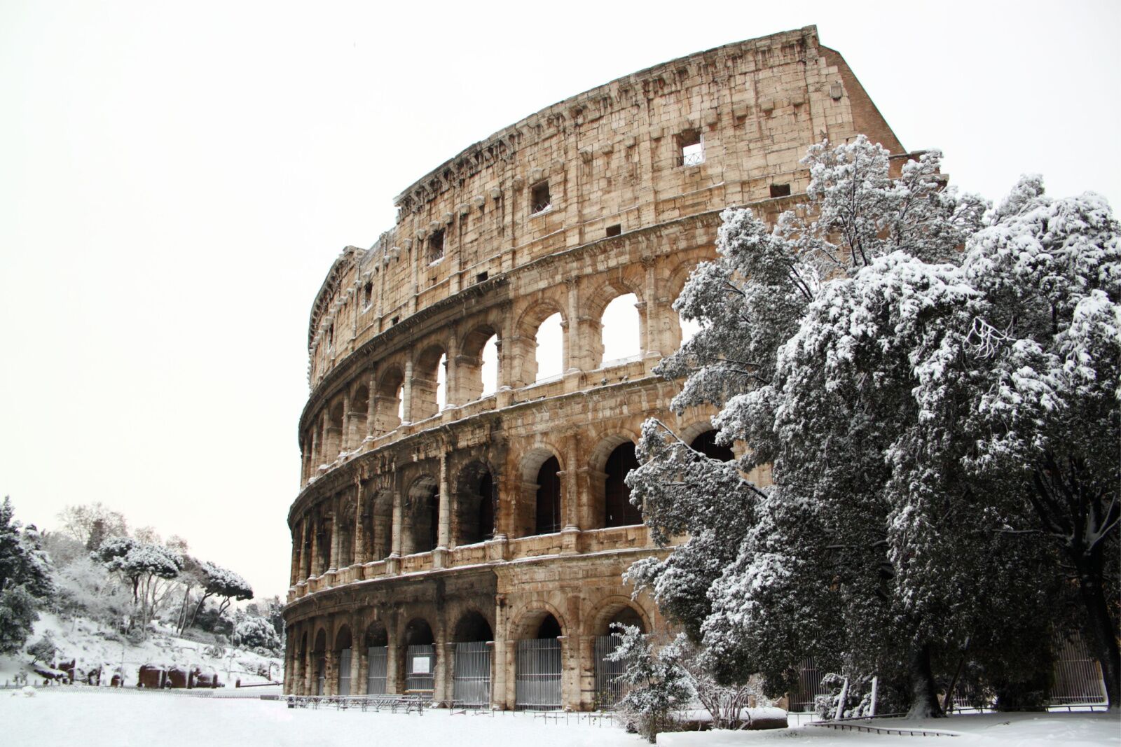 best time to visit italy snow in rome on colosseum