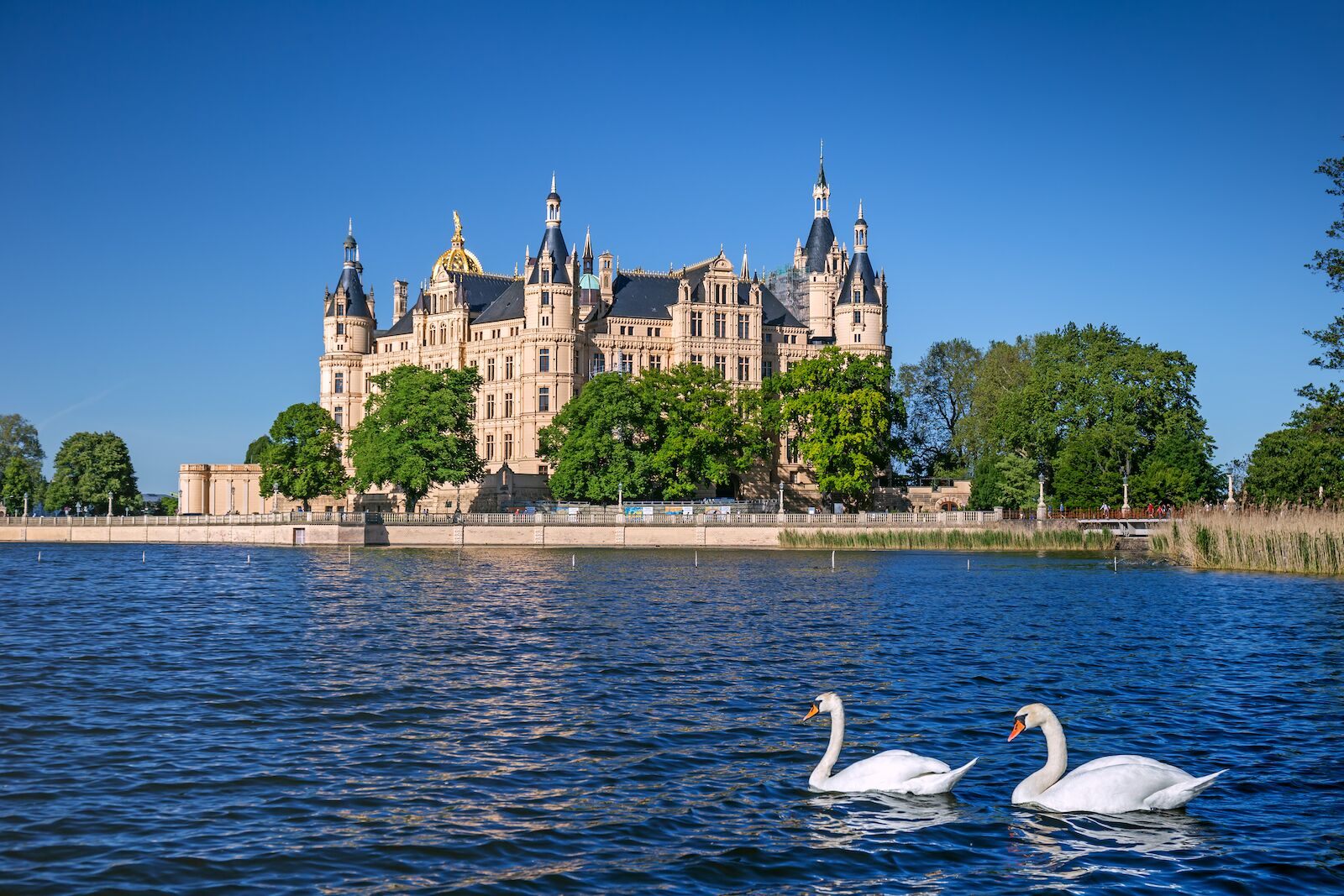 View of the Schwerin medieval castle from the lake with swans, Germany