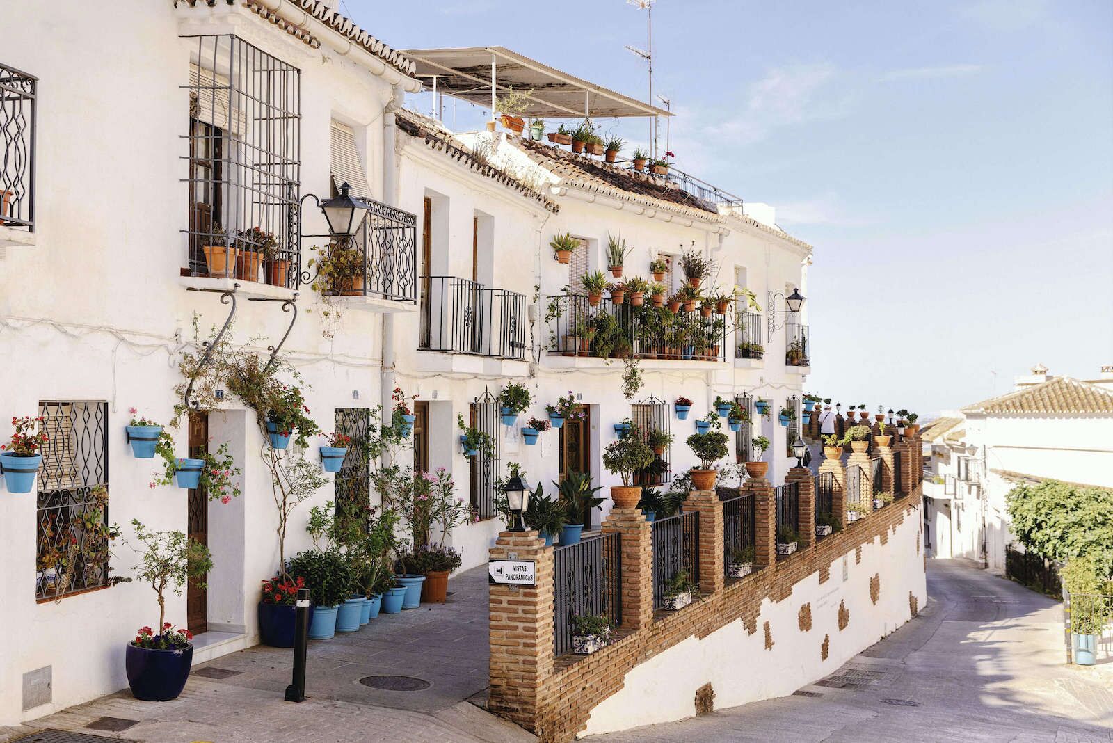 buildings in the town of Marbella with terraces and flowers in the windows