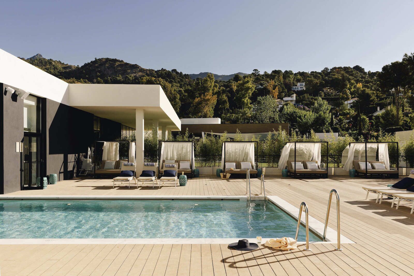 The pool and pool deck with cabanas and umbrellas at Club Med Magna Marbella