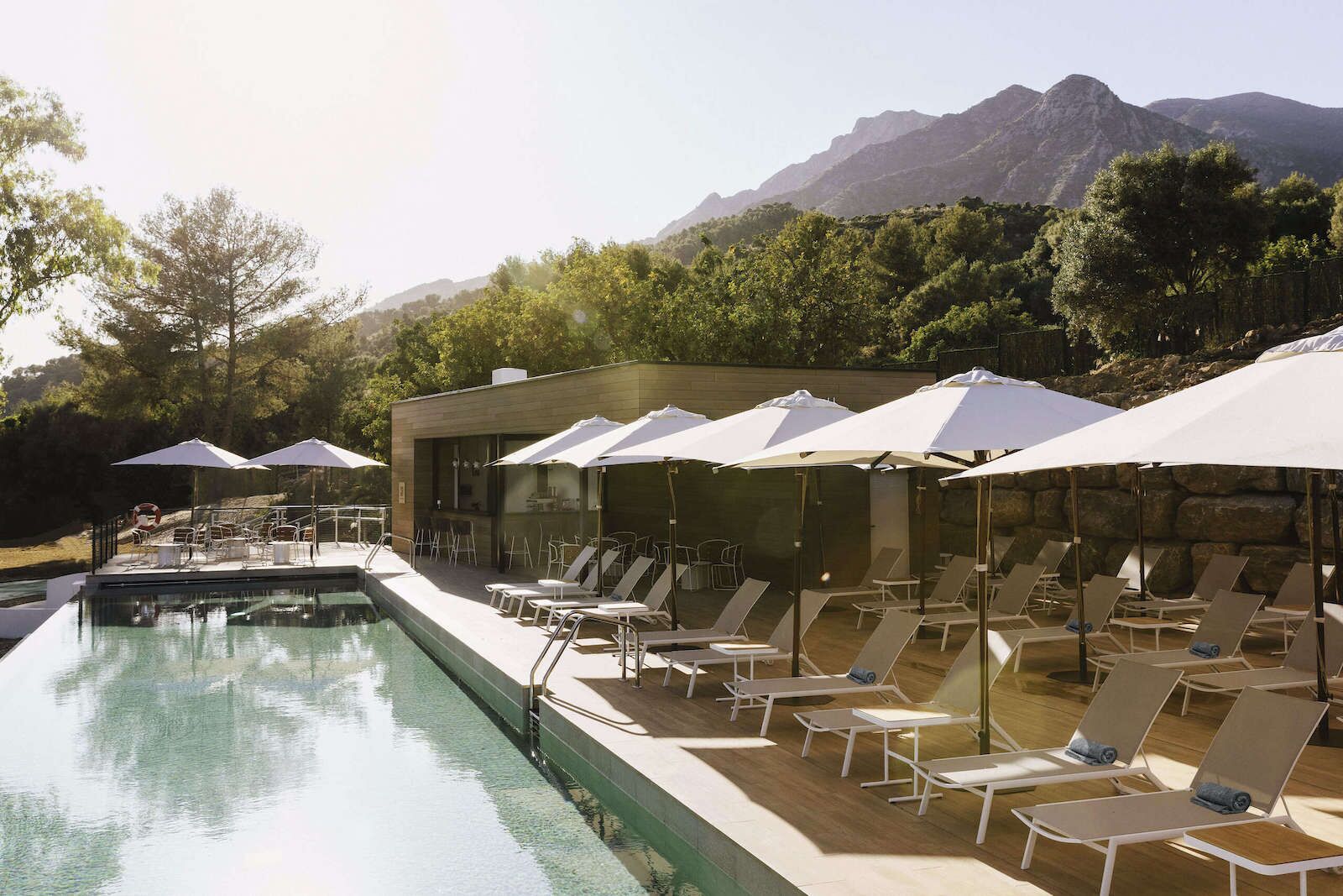 One of the pools at Club Med Magna Marbella with white umbrellas