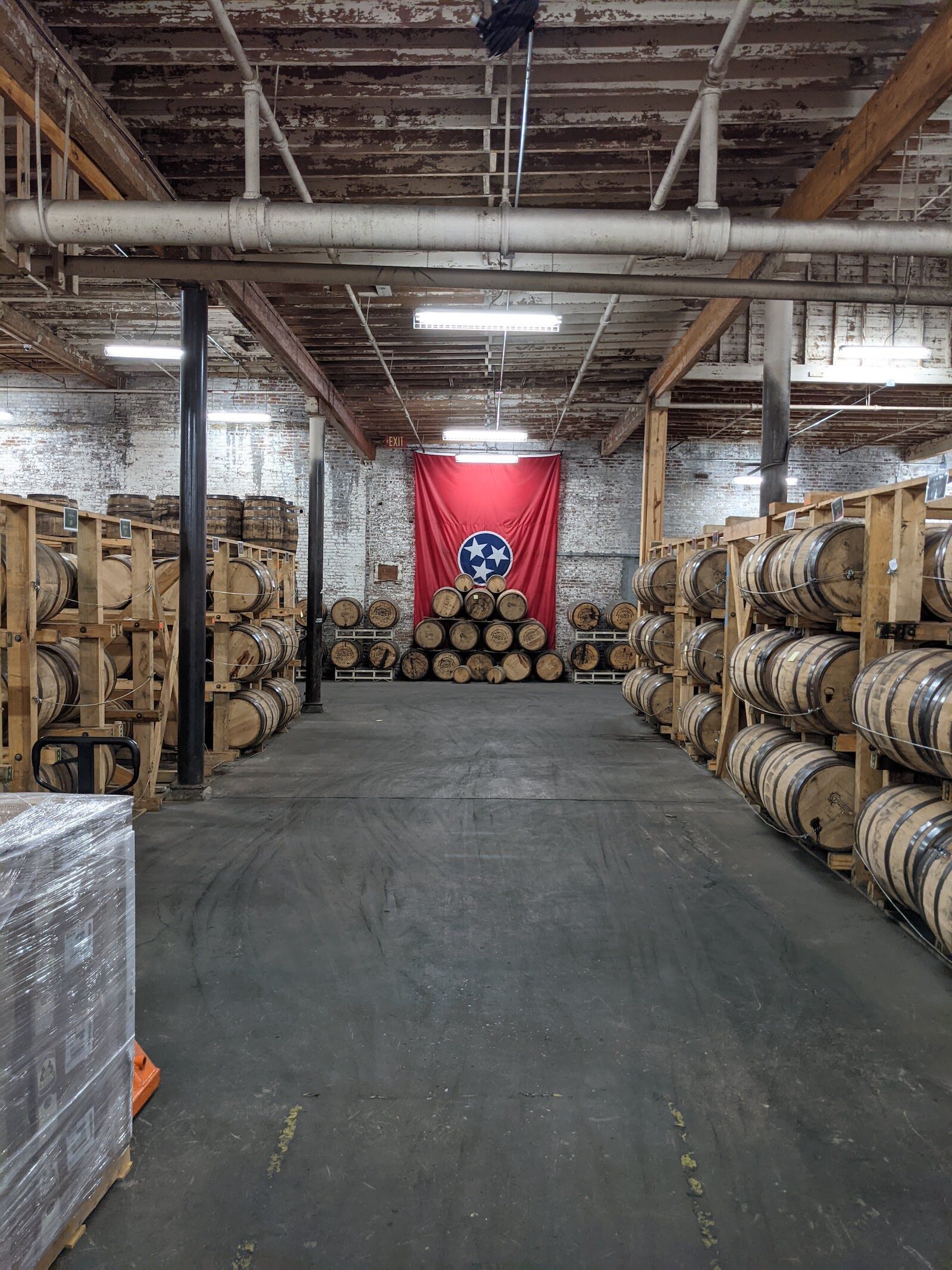 Inside the barrel room at Nelson's Green Brier, with cement floors, and wooden barrels on each side, in Nashville, one of the best bourbon cities