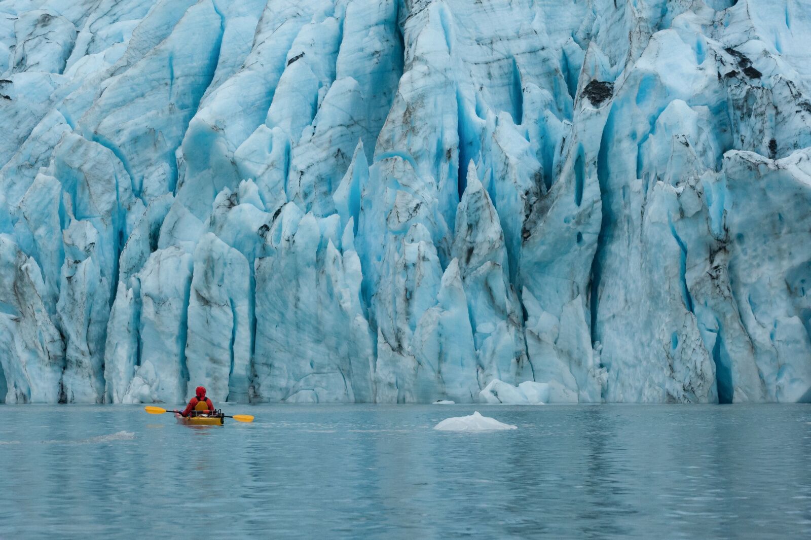 kayaker in front of a glacier in Alaska