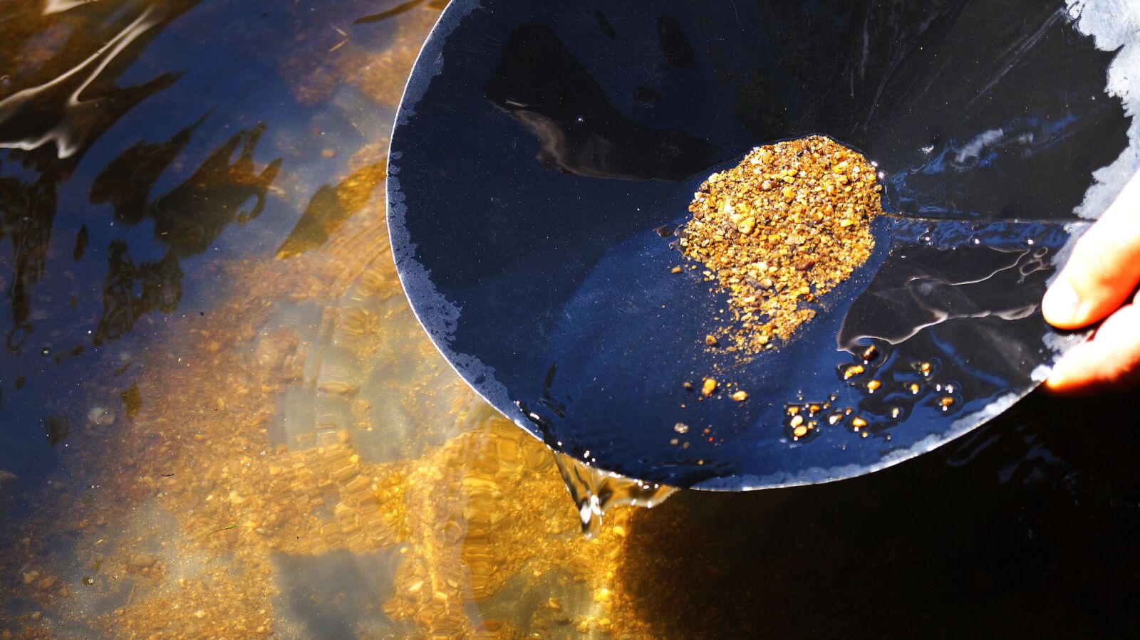 Close up of hands panning for gold in alaska 