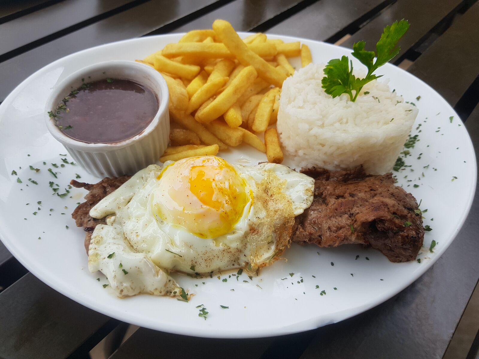 This Colombian breakfast is known as steak on horseback, a steak topped with a fried egg served with aside of rice