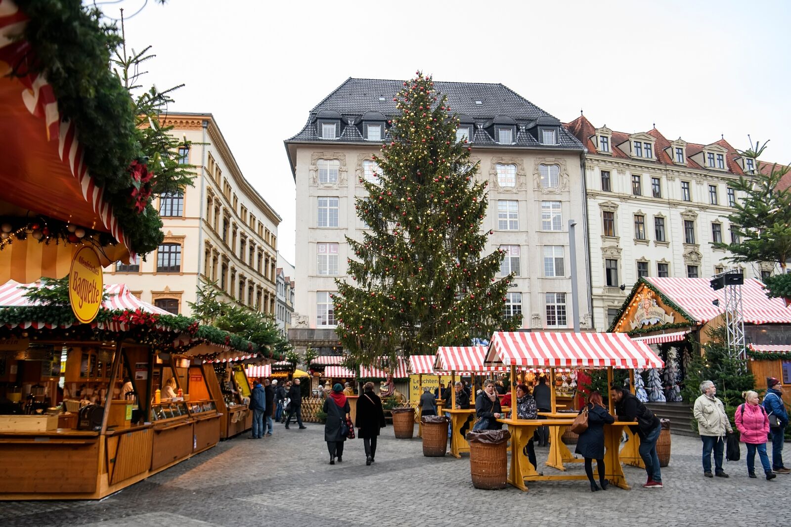 Traditional Festive Christmas fair with Christmas Tree at Marktplatz Market Square in front of the Old Town Hall. Leipzig, Germany one of the best Christmas markets in Europe