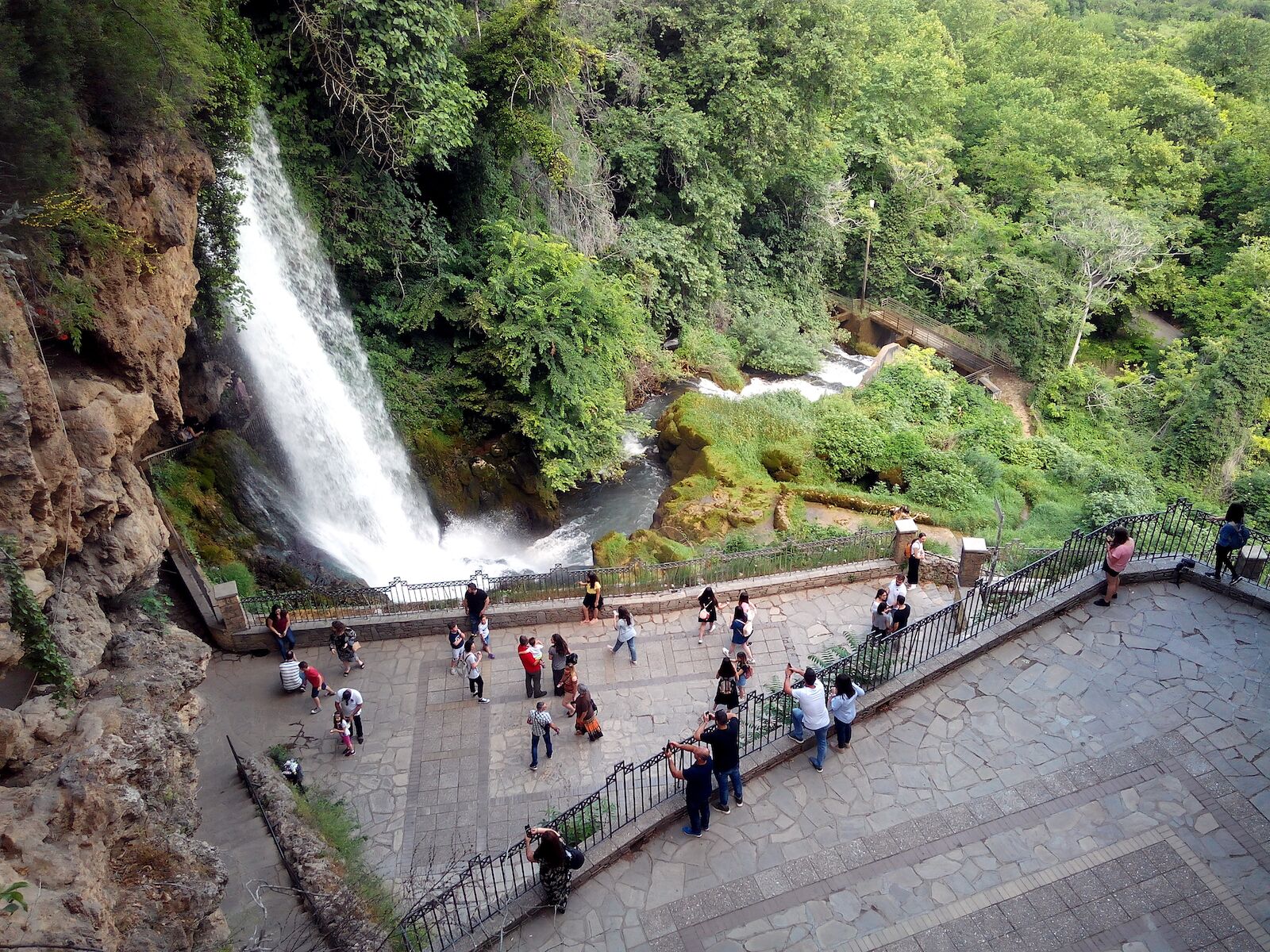 EDESSA, GREECE - MAY 28, 2018: Tourists taking photos with the Karanos waterfall of the Edessaios river. The waterfall measures 70 metres in height and is the biggest one in Greece.