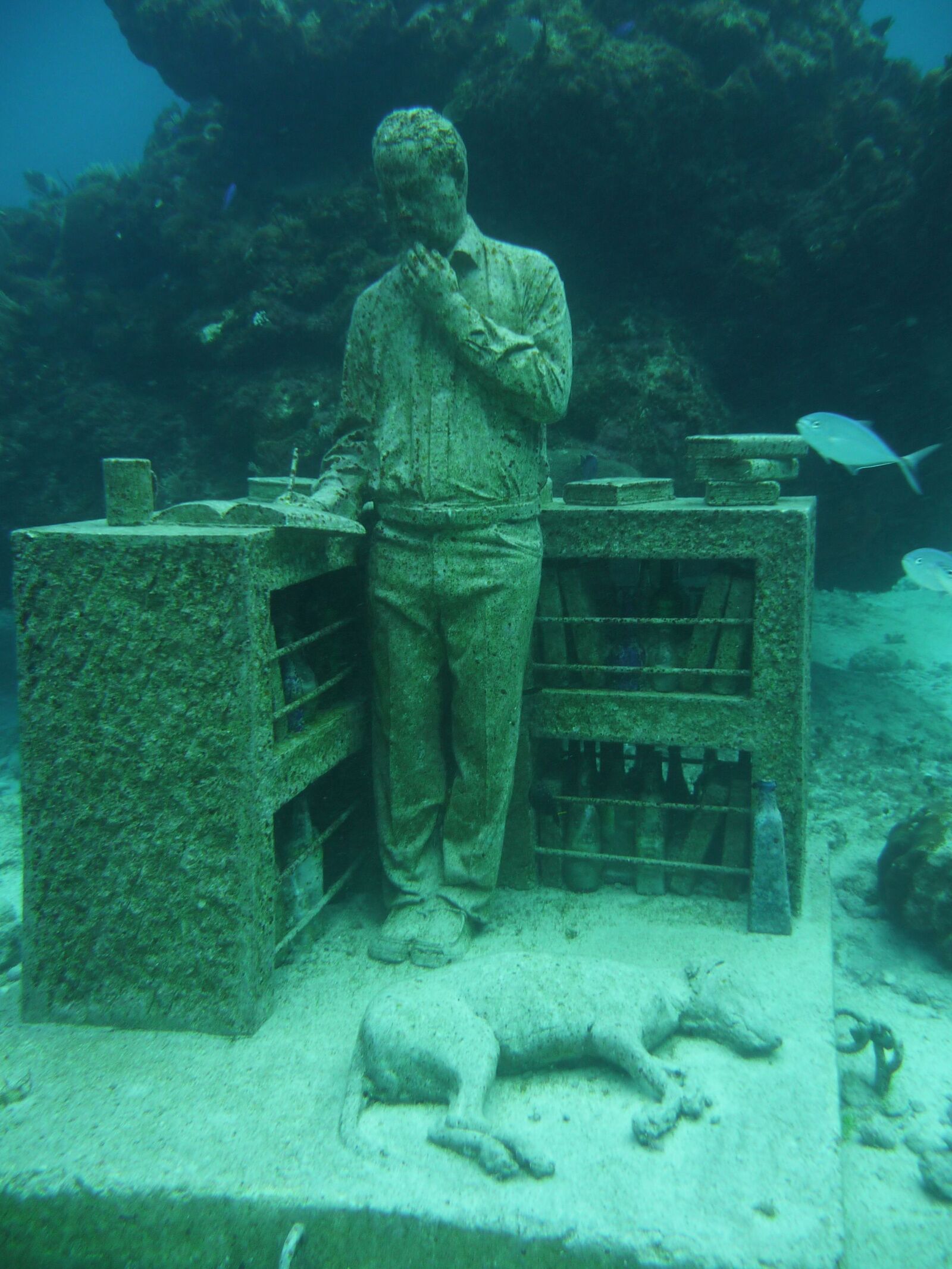 Cancun underwater museum sculpture of guy at a desk