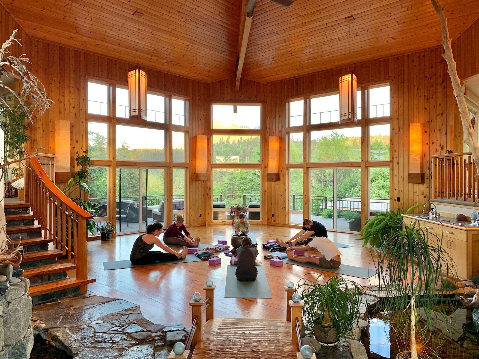 People doing yoga on the floor inside at Stillpoint Lodge, Alaska