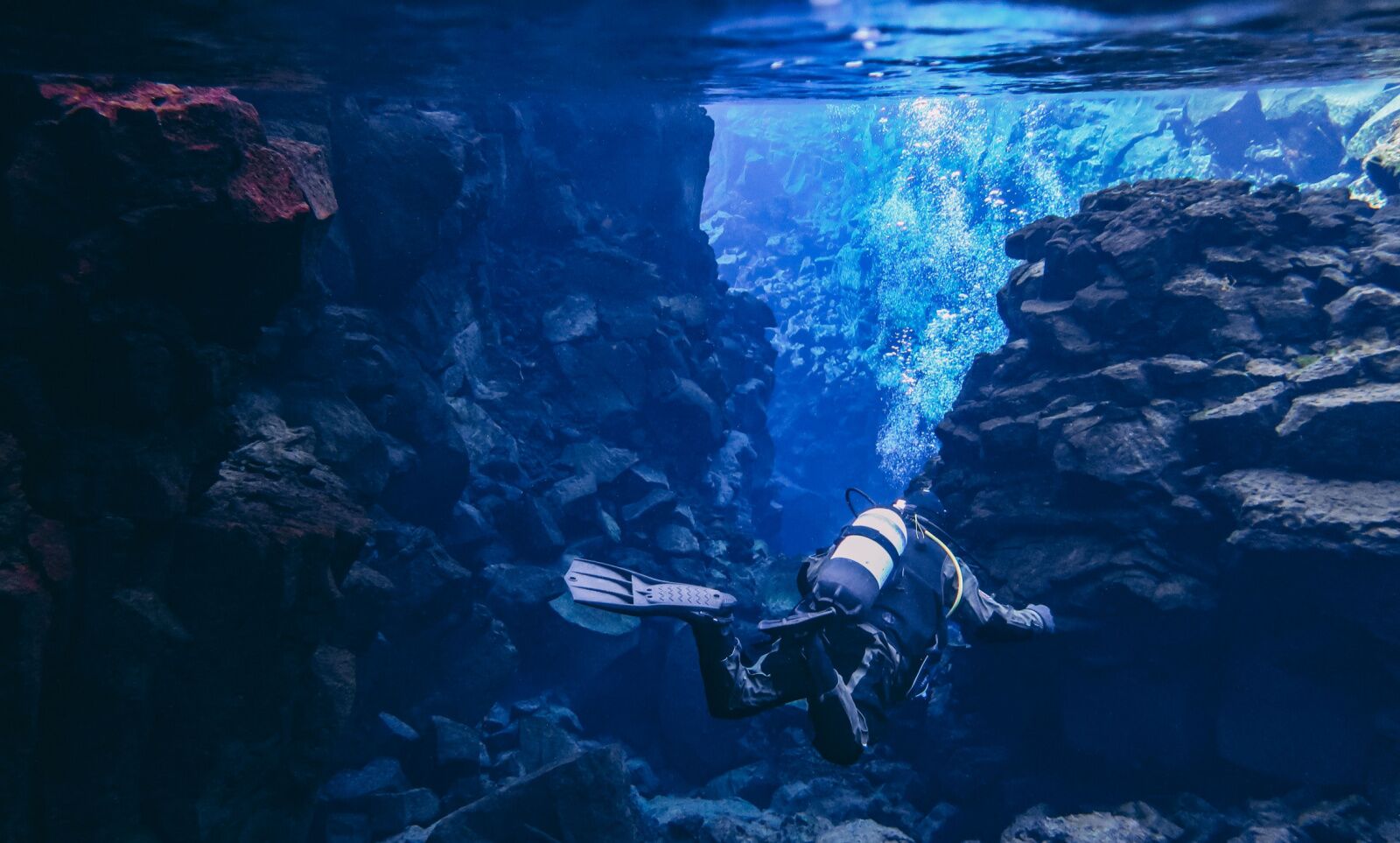 Person in the silfra fissure, doing silfra diving in Iceland underwater