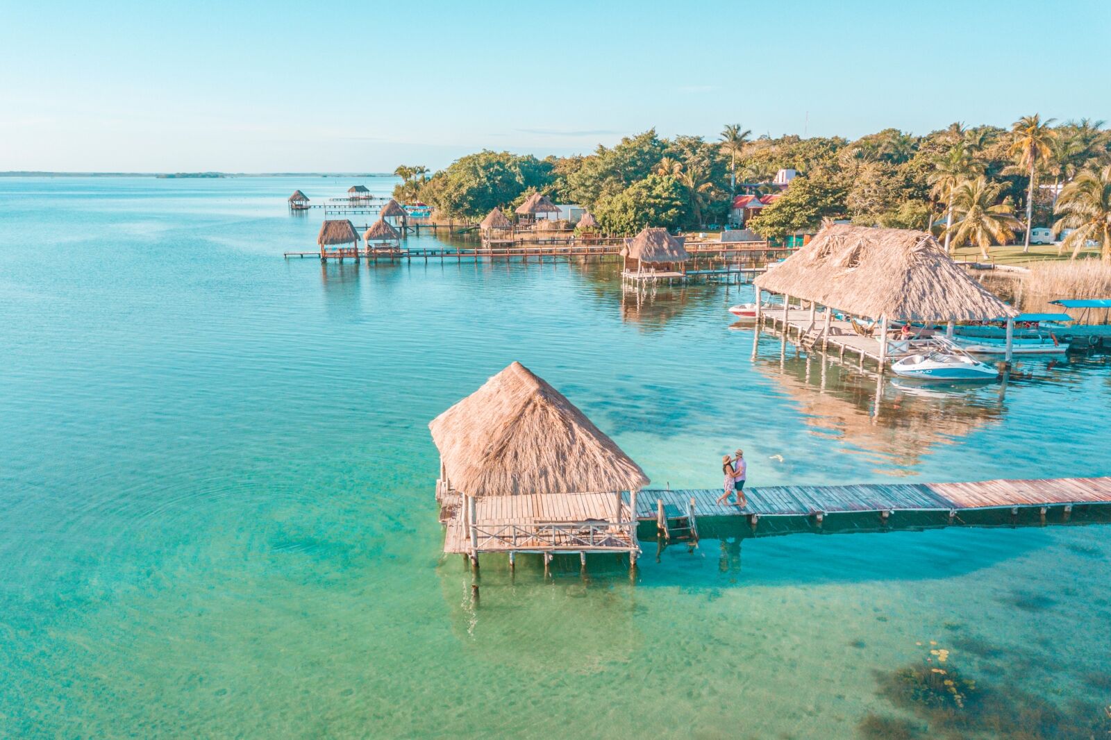 Aerial view of a Couple in Bacalar pier, Riviera Maya, one of the best places in Mexico for couples
