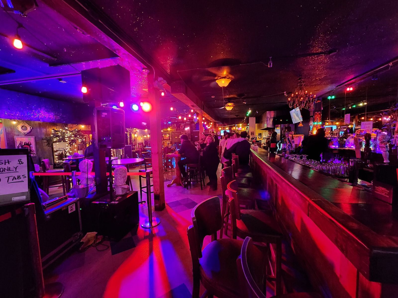 Red lighting and packed bar inside Hidden Cove 