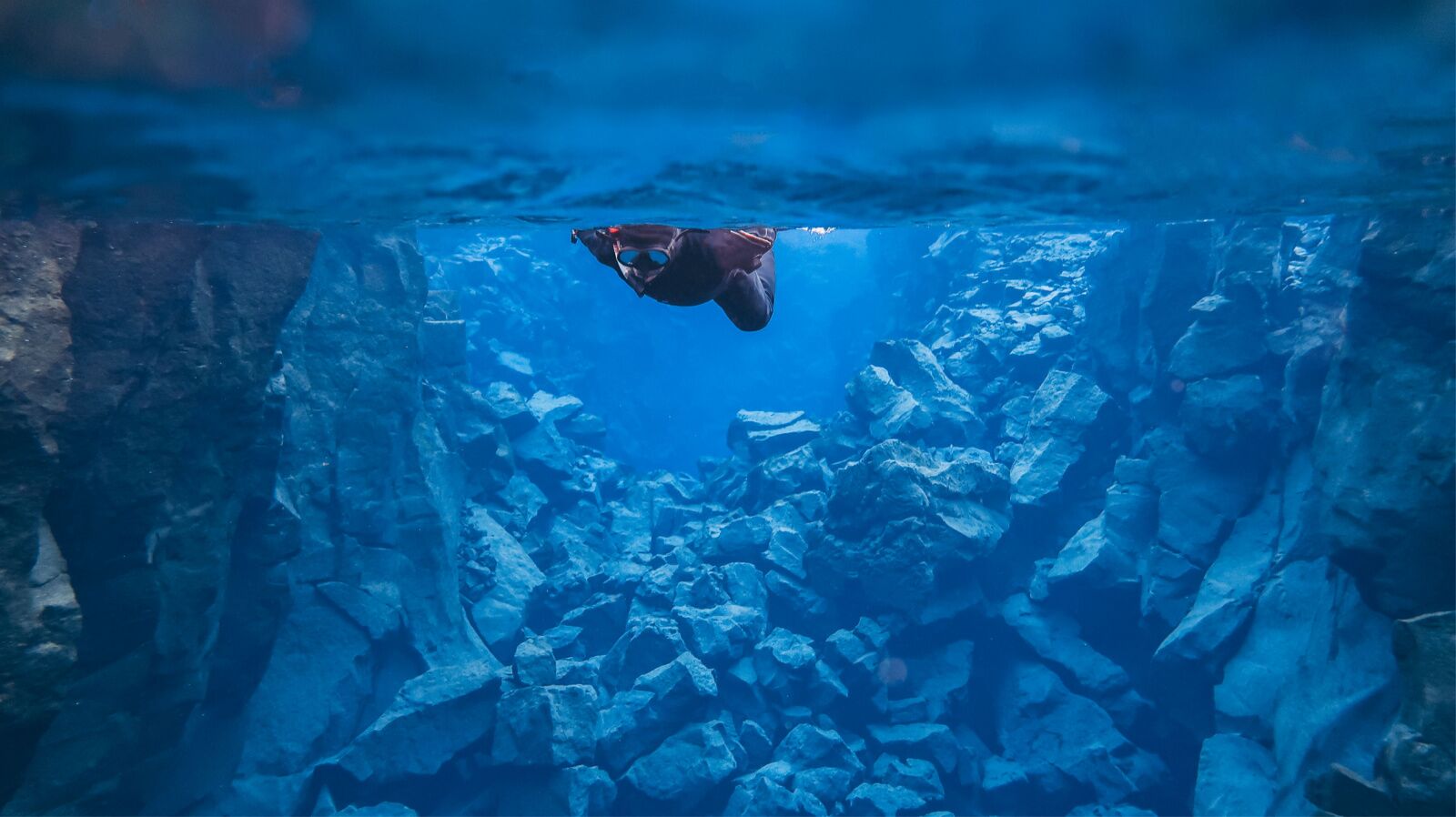 silfra diving - snorkeler above the fissure