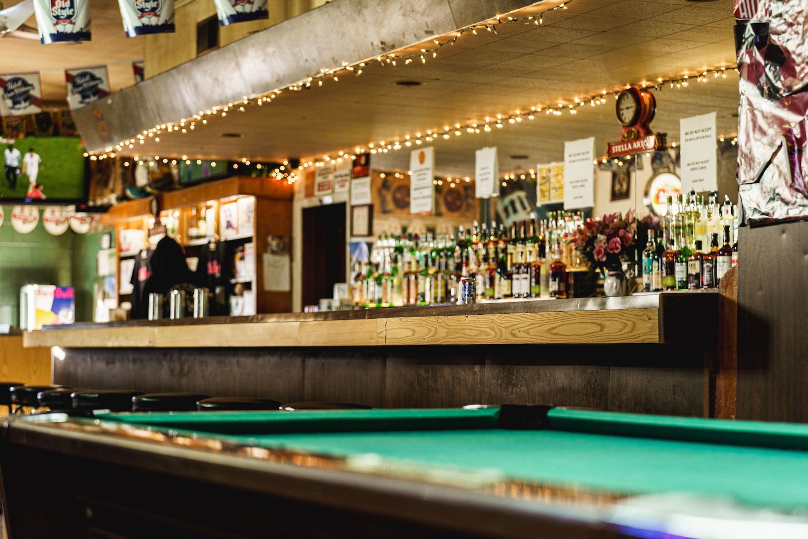 dive bar Chicago called Stellas with pool table and Pabst blue ribbon can on the bar