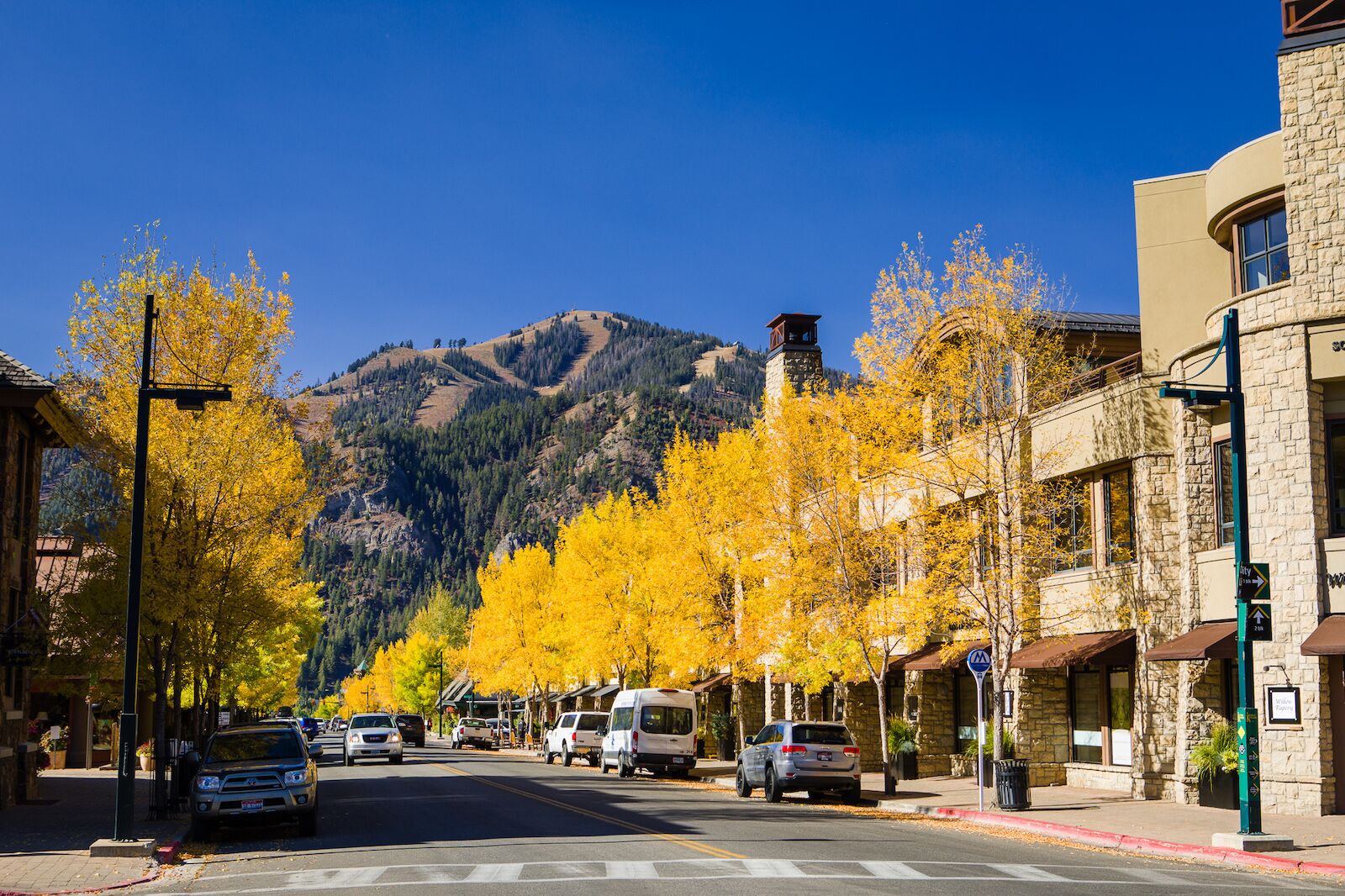 Downtown Sun Valley Idaho on a fall day with leaves turning yellow on the trees and cars parked on the street