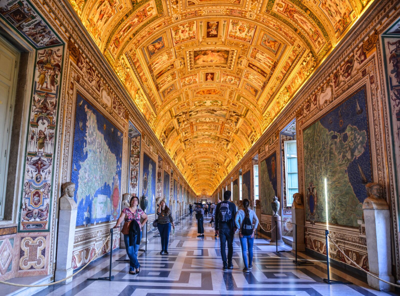 people in the halls of teh vatican museum, considered one of the best museums in rome