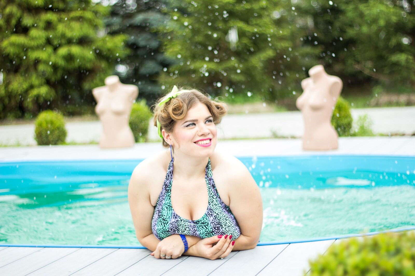 Plus-size spa woman at an outdoor pool looking super happy