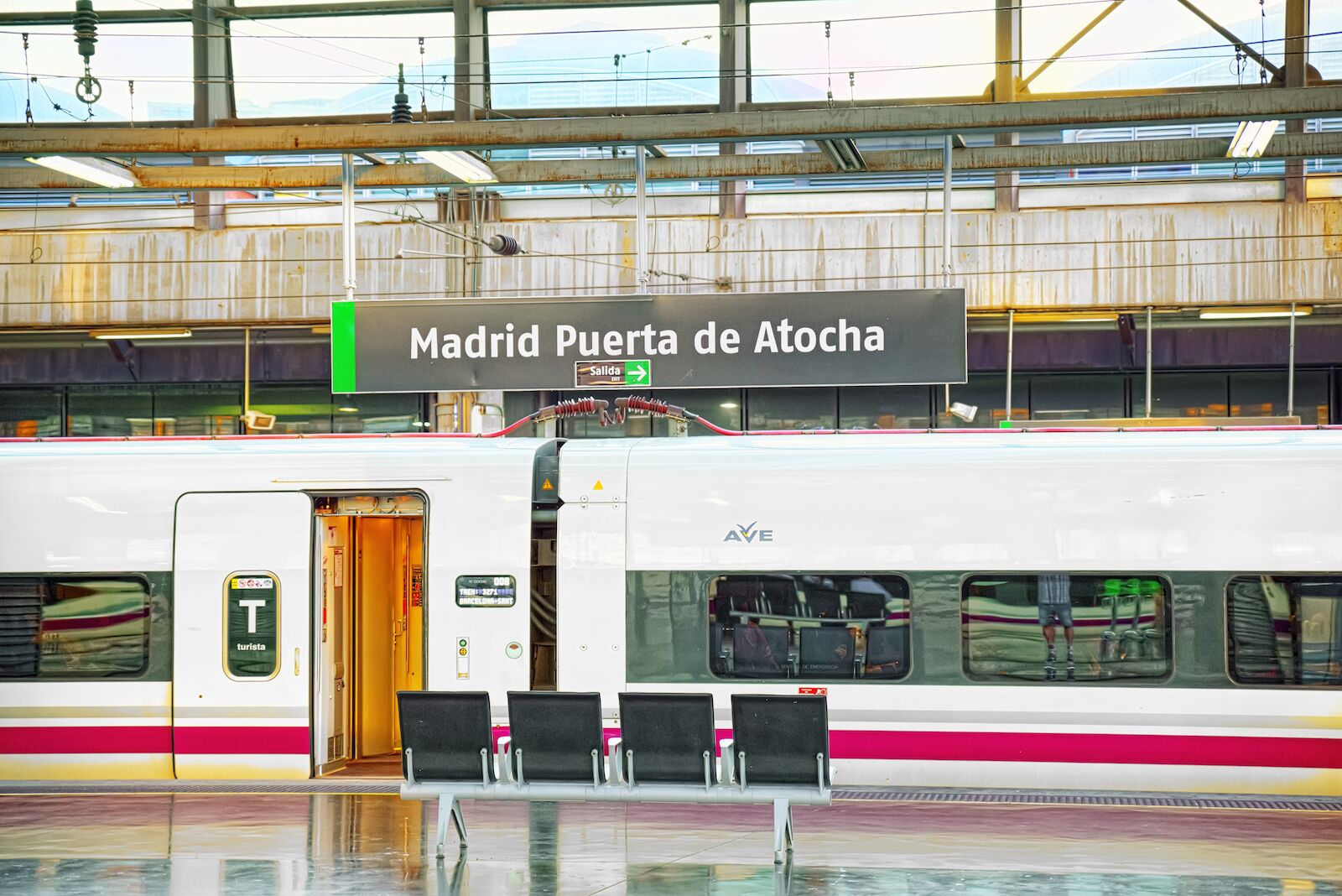 AVE train in the Madrid Puerta de Atocha train station in Madrid. AVE trains run between Madrid and Barcelona multiple times daily.