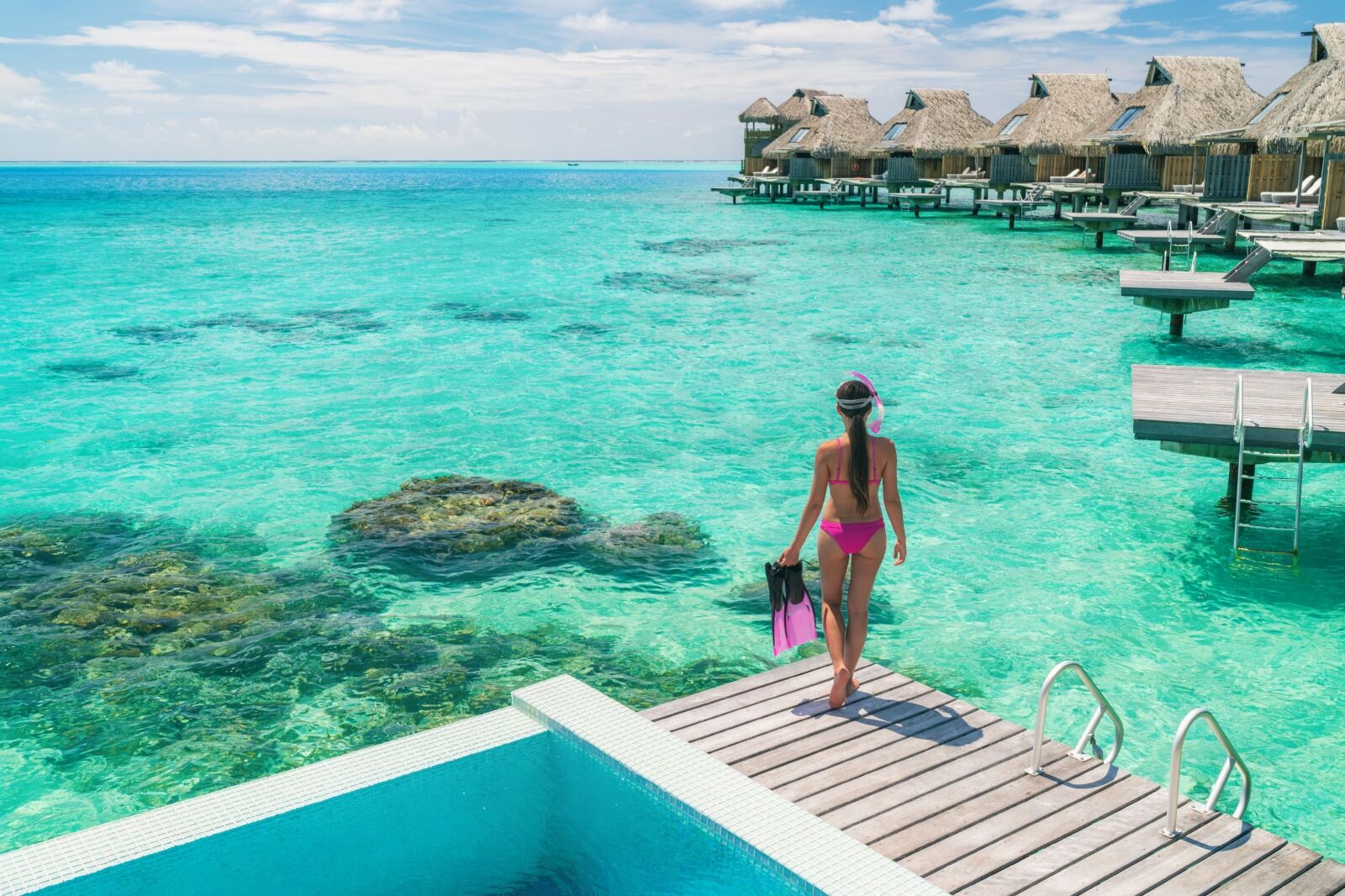 Woman in Maldive near overwater bungalows 