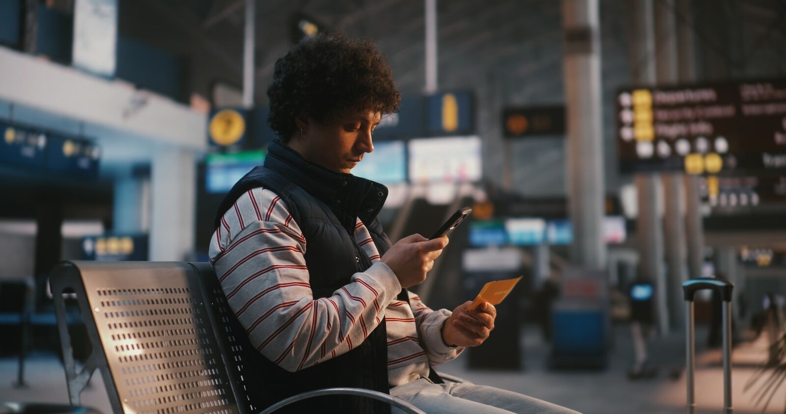 man holding credit card at airport