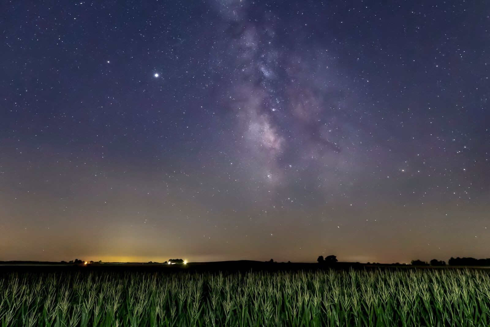 The Milky Way Galaxy arcs through a starry summer dark sky over an Indiana