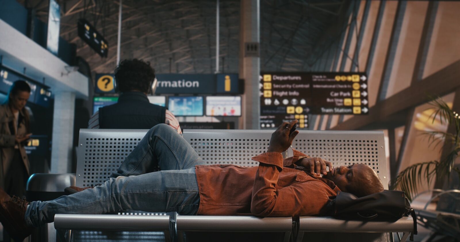 man laying down in airport