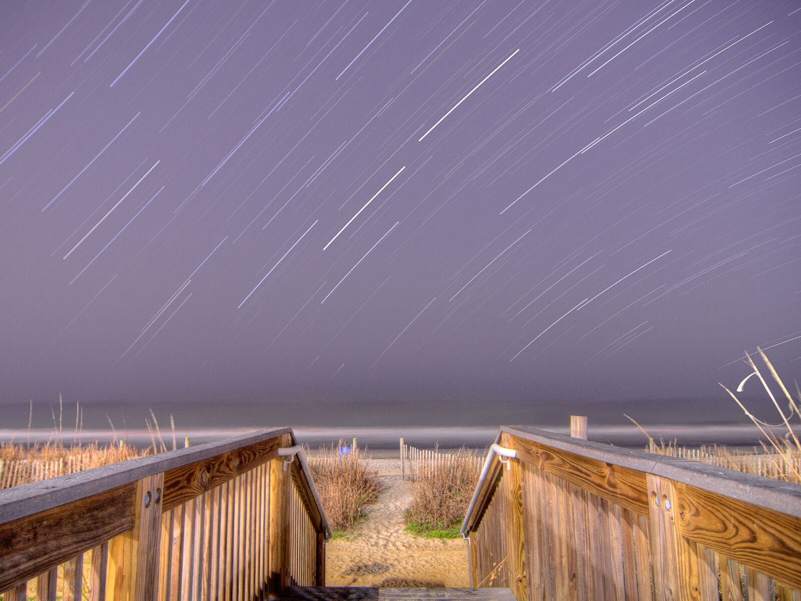 astrophotography star trails over beach