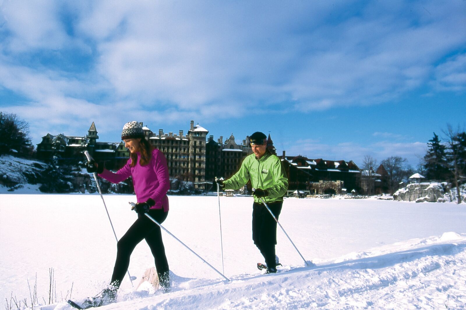Couple skiing in front of Mohonk Mountain House
