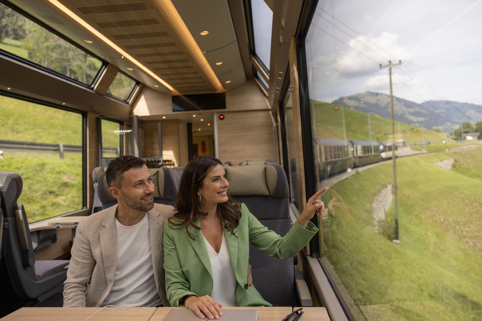 Couple on GoldenPass train part of the Swiss Travel System