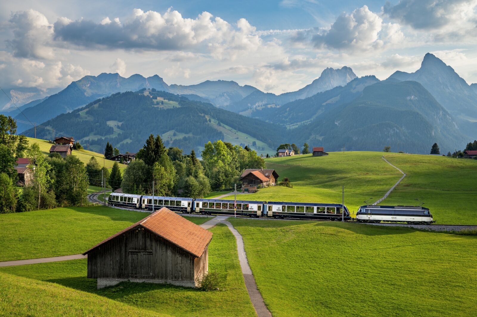 Mountains and Swiss landscape with GoldenPass Express train part of the Swiss Travel System 