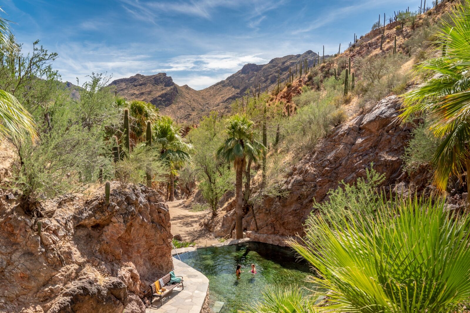 Pool with two people in at the natural hot springs at Castle Hot Springs in Arizona