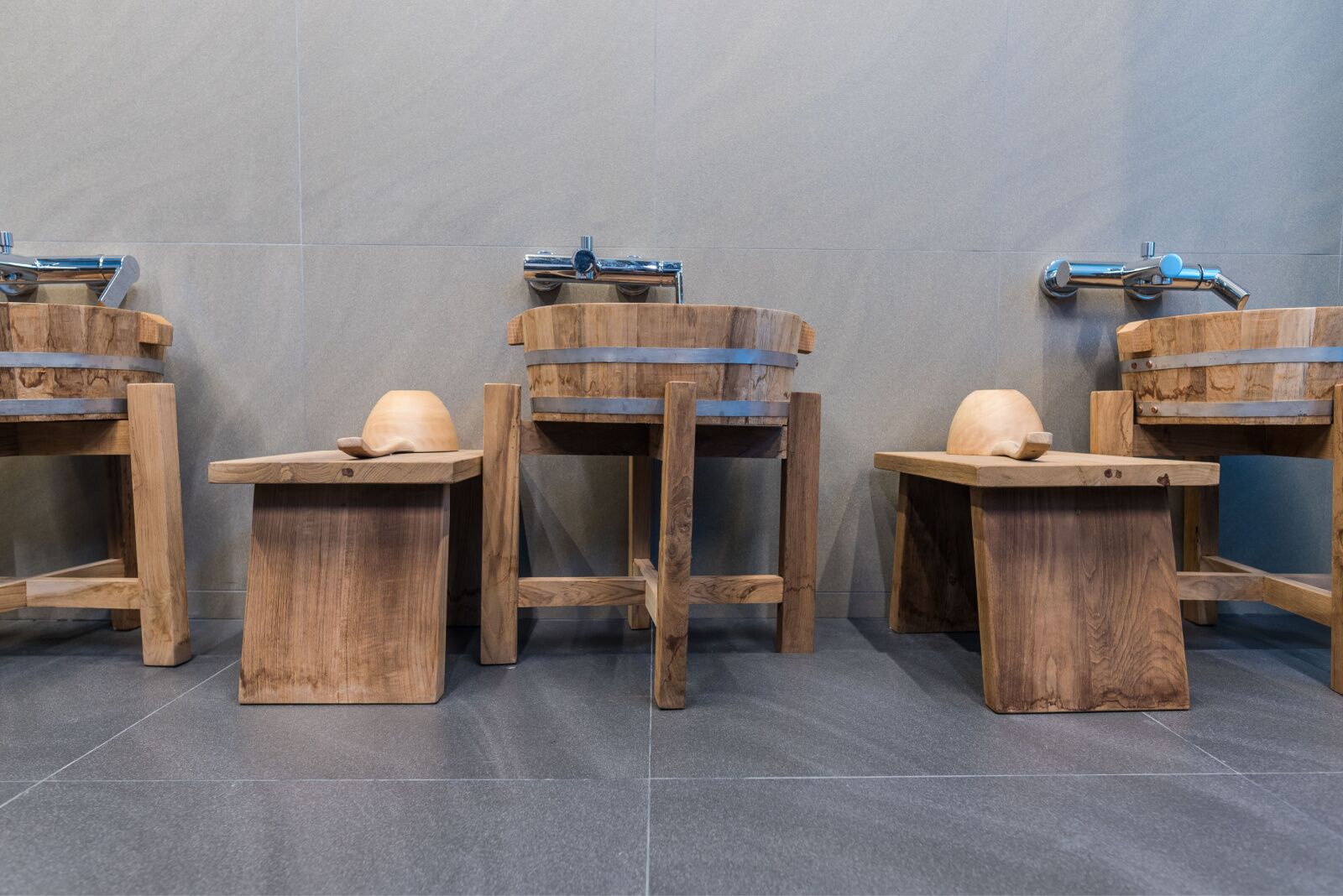 Rows of wooden stools at a Japanese onsen 