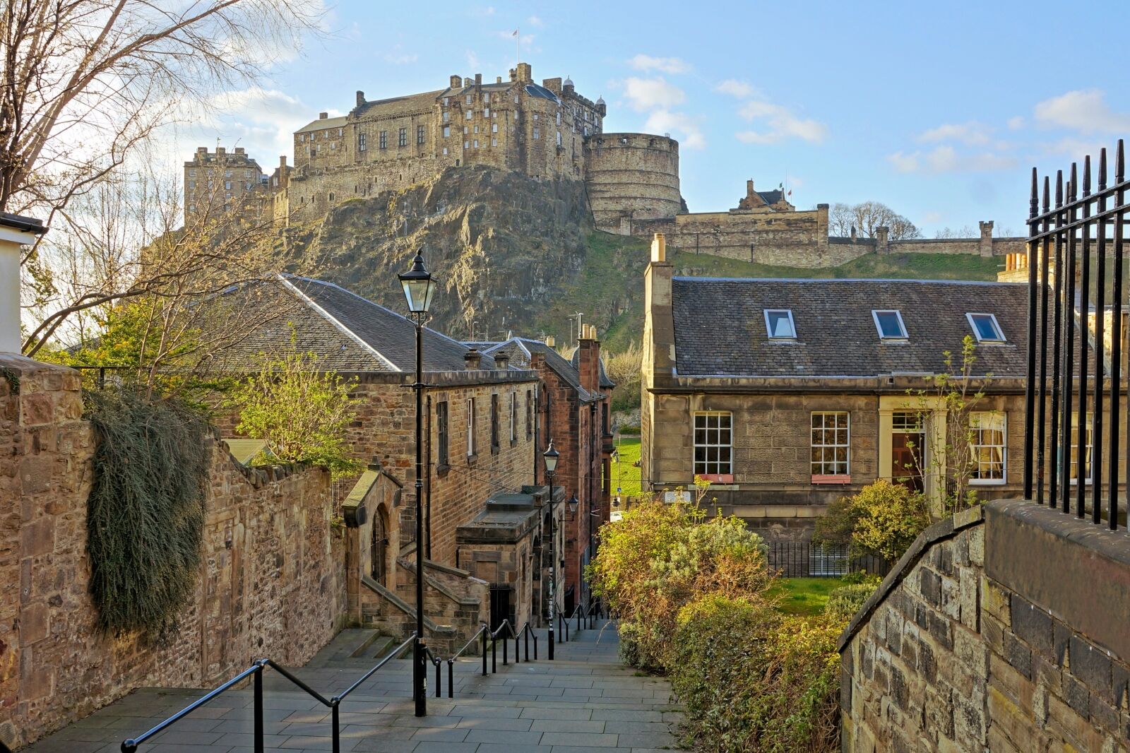 View of Edinburgh castle from the medieval streets of the old town one of the best things to do in Edinburgh