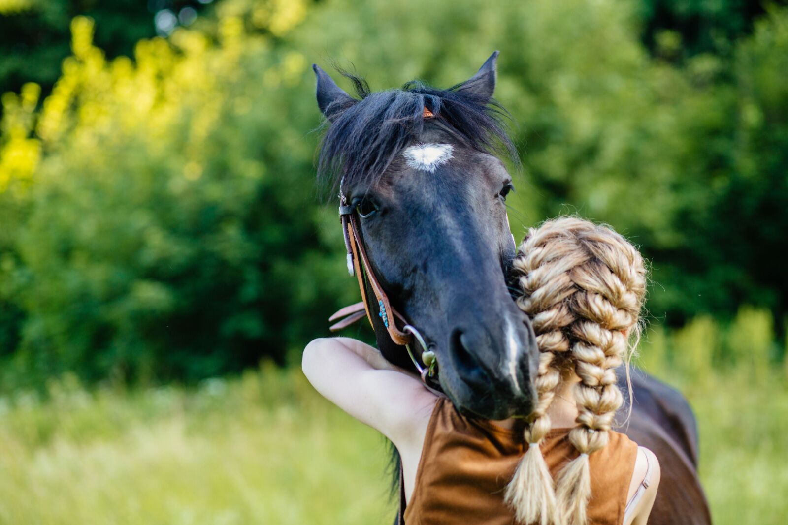 Woman hugging horse at an equine therapy retreat