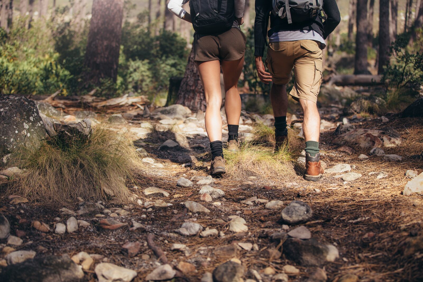 man and woman hiking in woods
