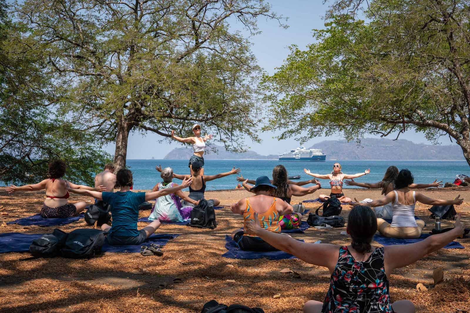 Outdoor on-shore yoga with Chopra Swan Hellenic wellness cruise