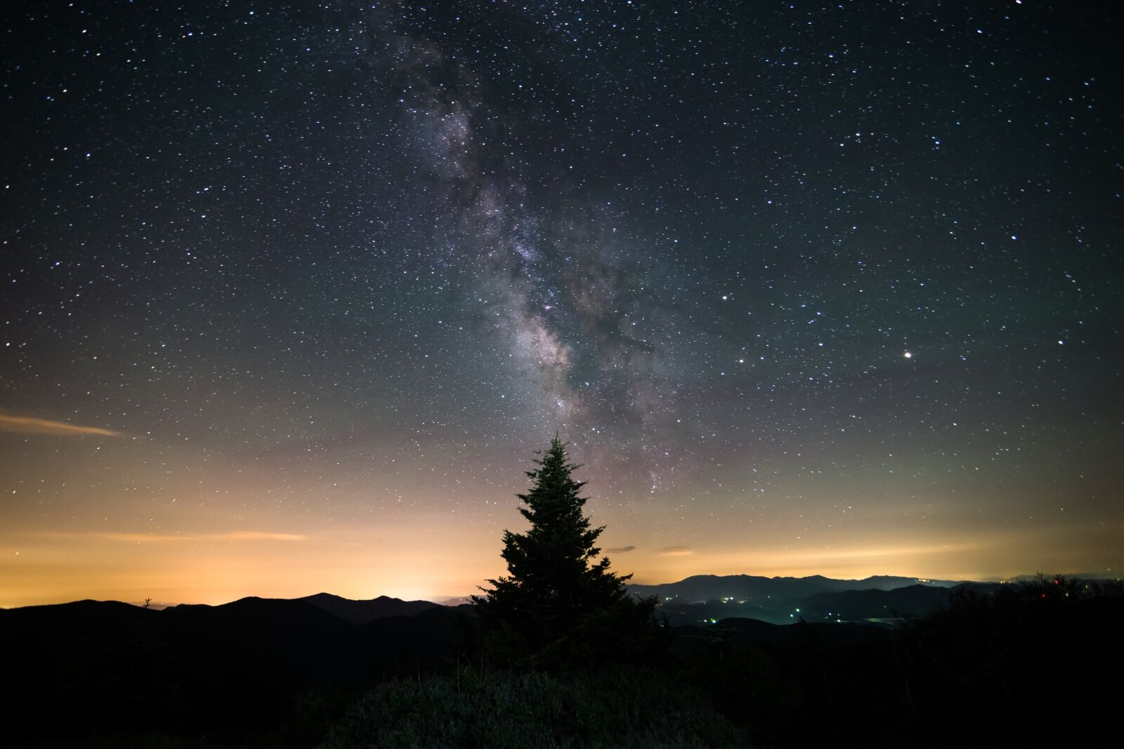 The milky way over the Blue Ridge Mountains on the border of North Carolina and Tennessee along the Appalachian Trail on Round Bald at the Roan Highlands. One of the best places to go stargazing in Tennessee