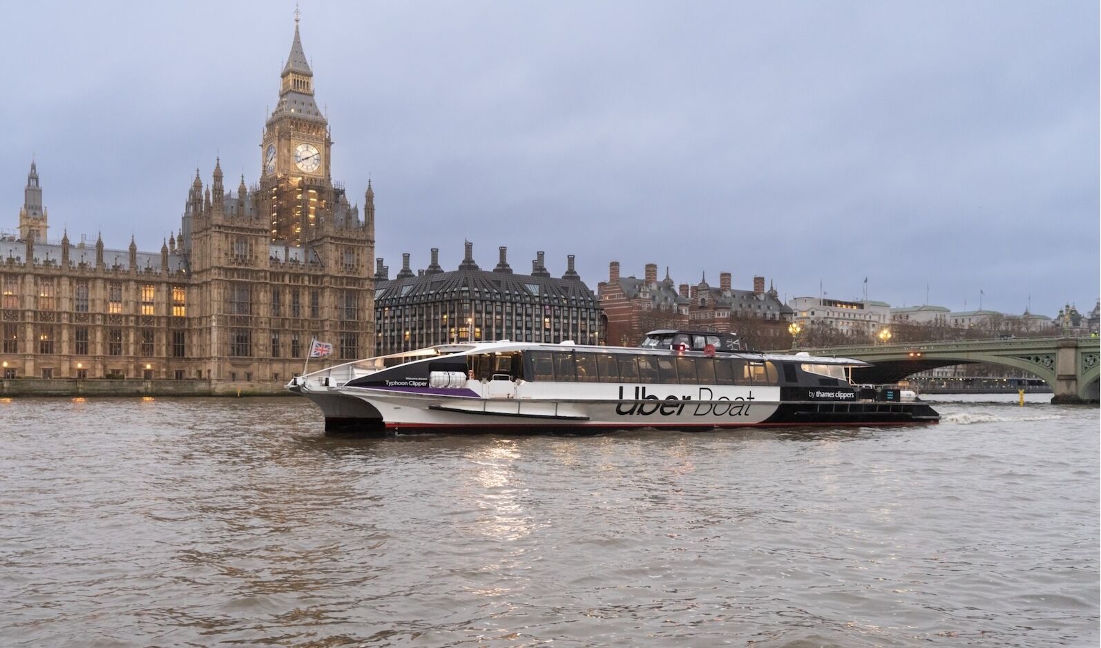 Uber Boat by Thames Clippers on the Thames river by the Palace of Westminster, London