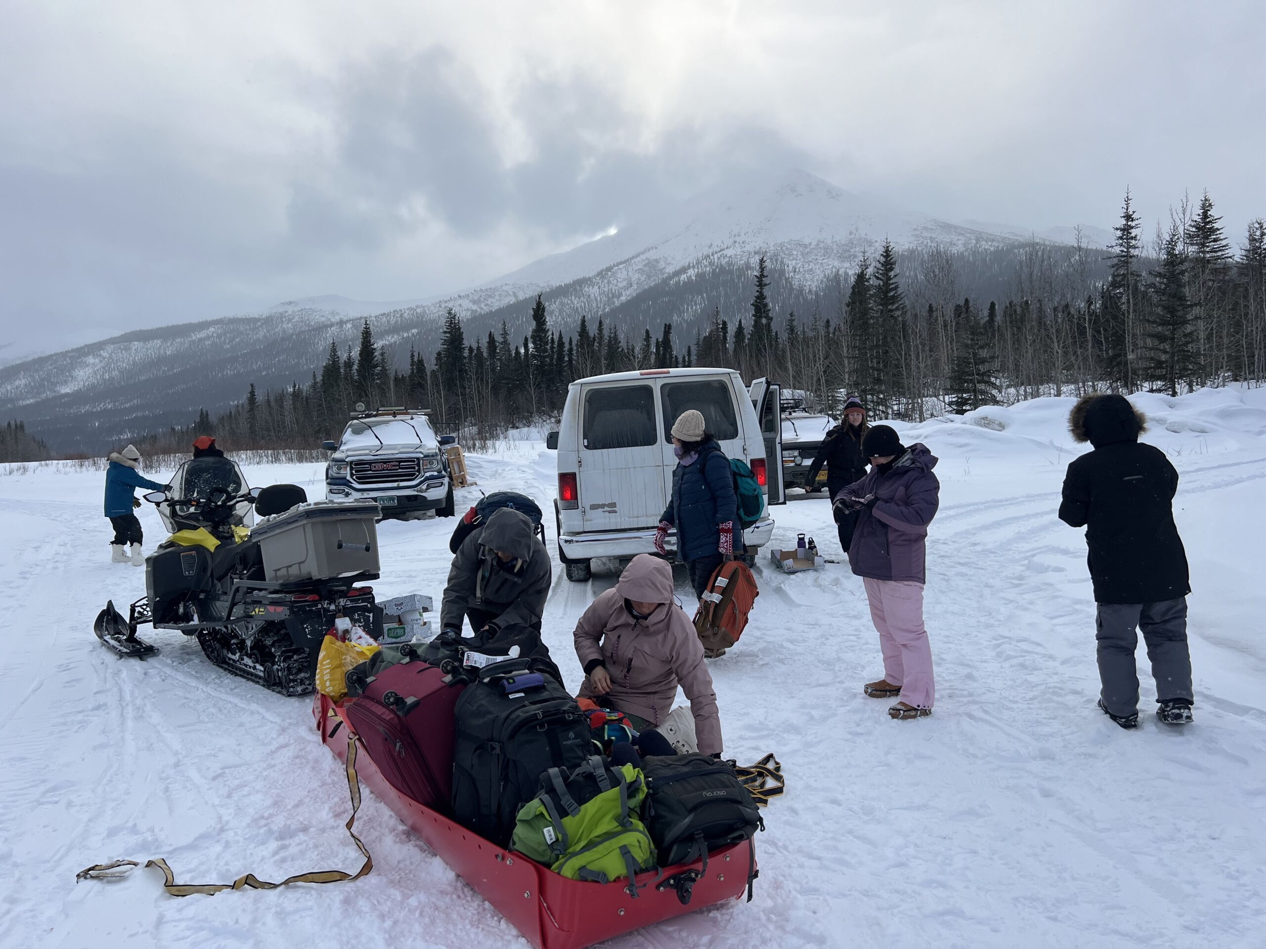 women with sled and luggage