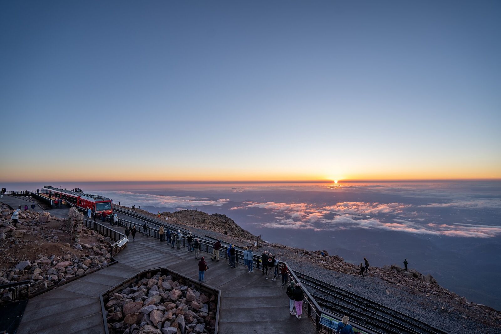 Broadmoor Manitou & Pikes Peak Cog Railway train at the summit of Pikes Peak where the view of the sunrise is magnificent