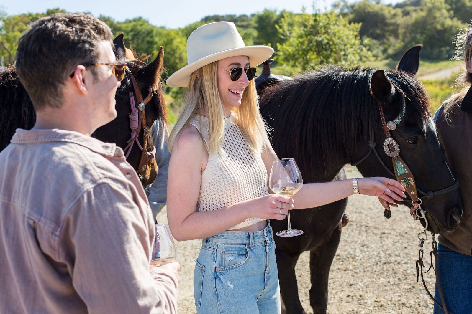 people with wine and a horse