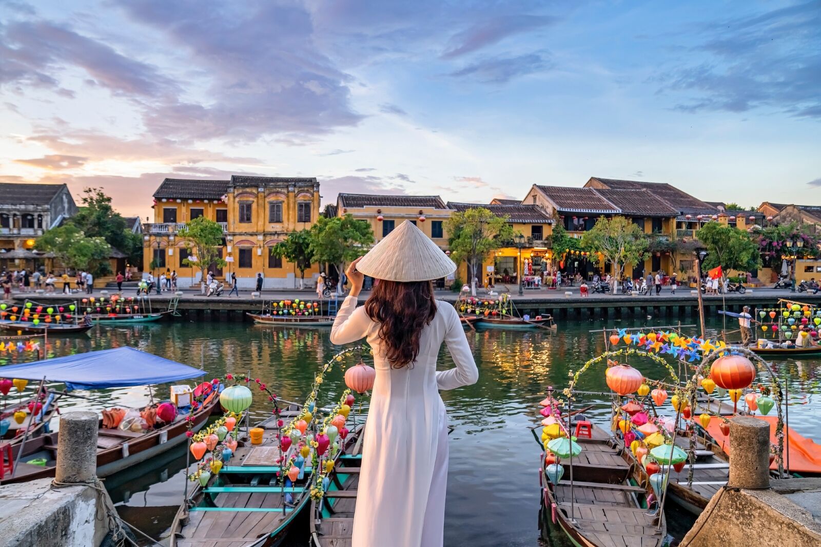 Asian woman wearing vietnam culture traditional at Hoi An ancient town, Vietnam.