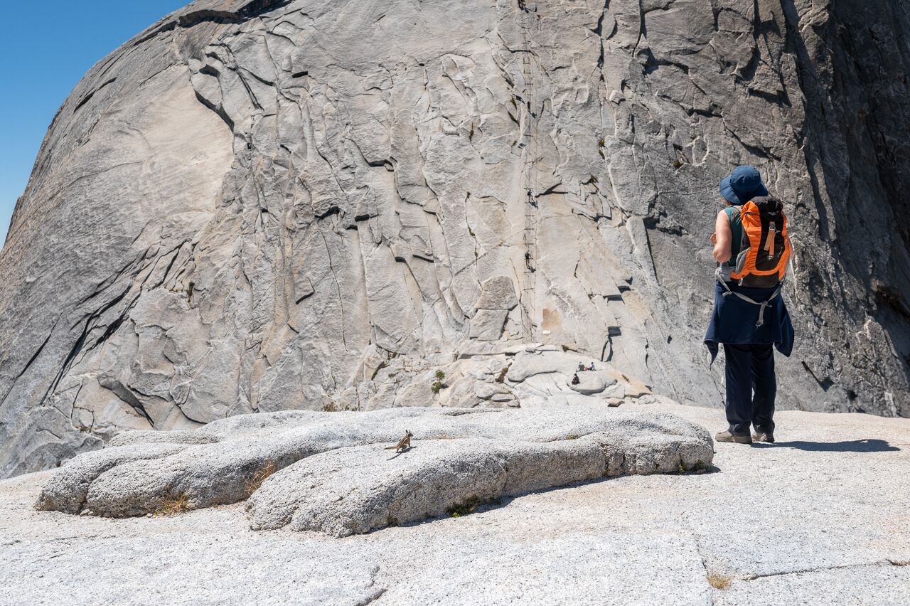 hiking half dome in yosemite national park. woman and chipmunk in the picture