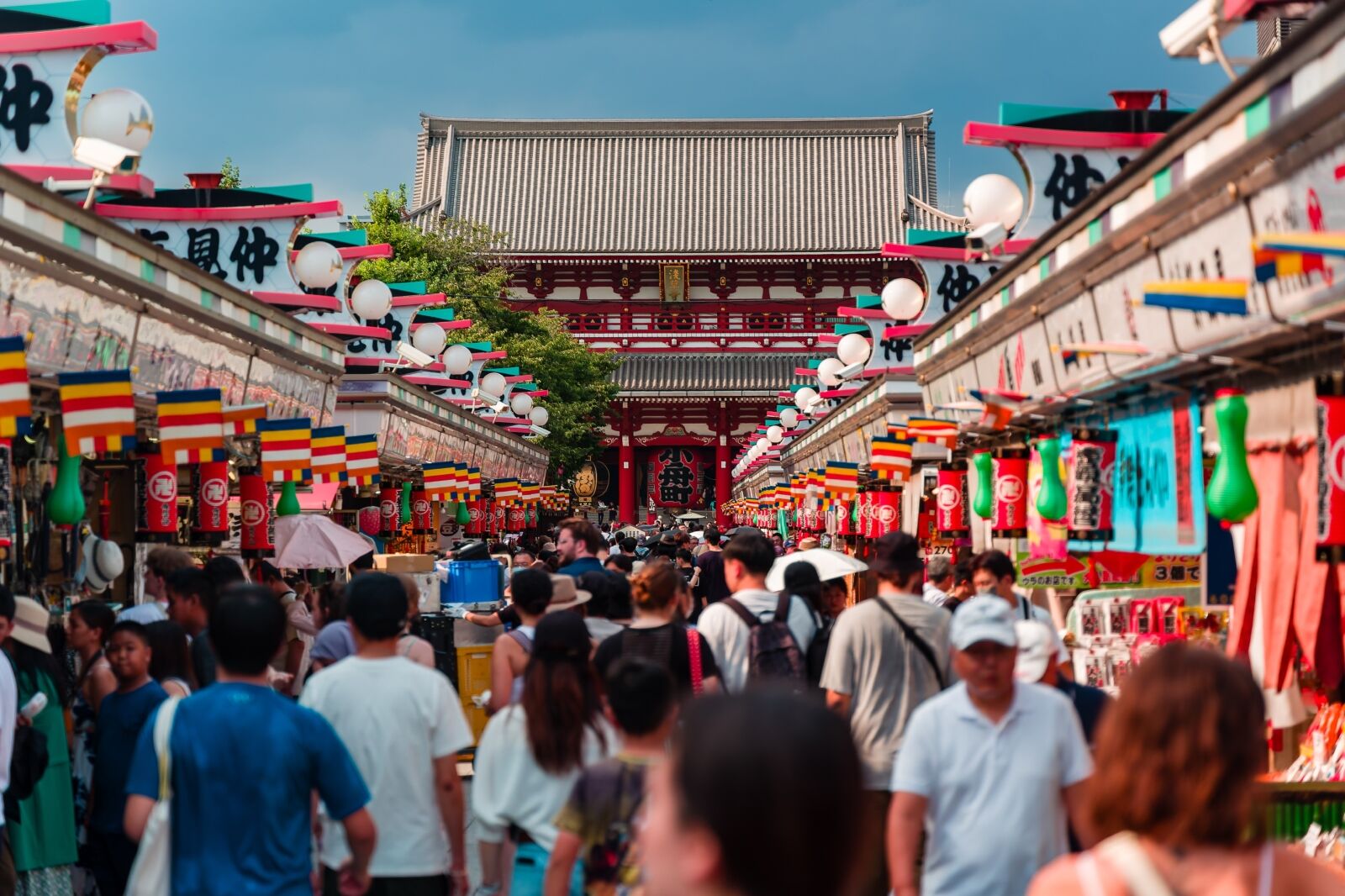 Crowds of tourists and locals pack Nakamise Dori Street leading towards the Senso-ji temple in Asakusa, Tokyo