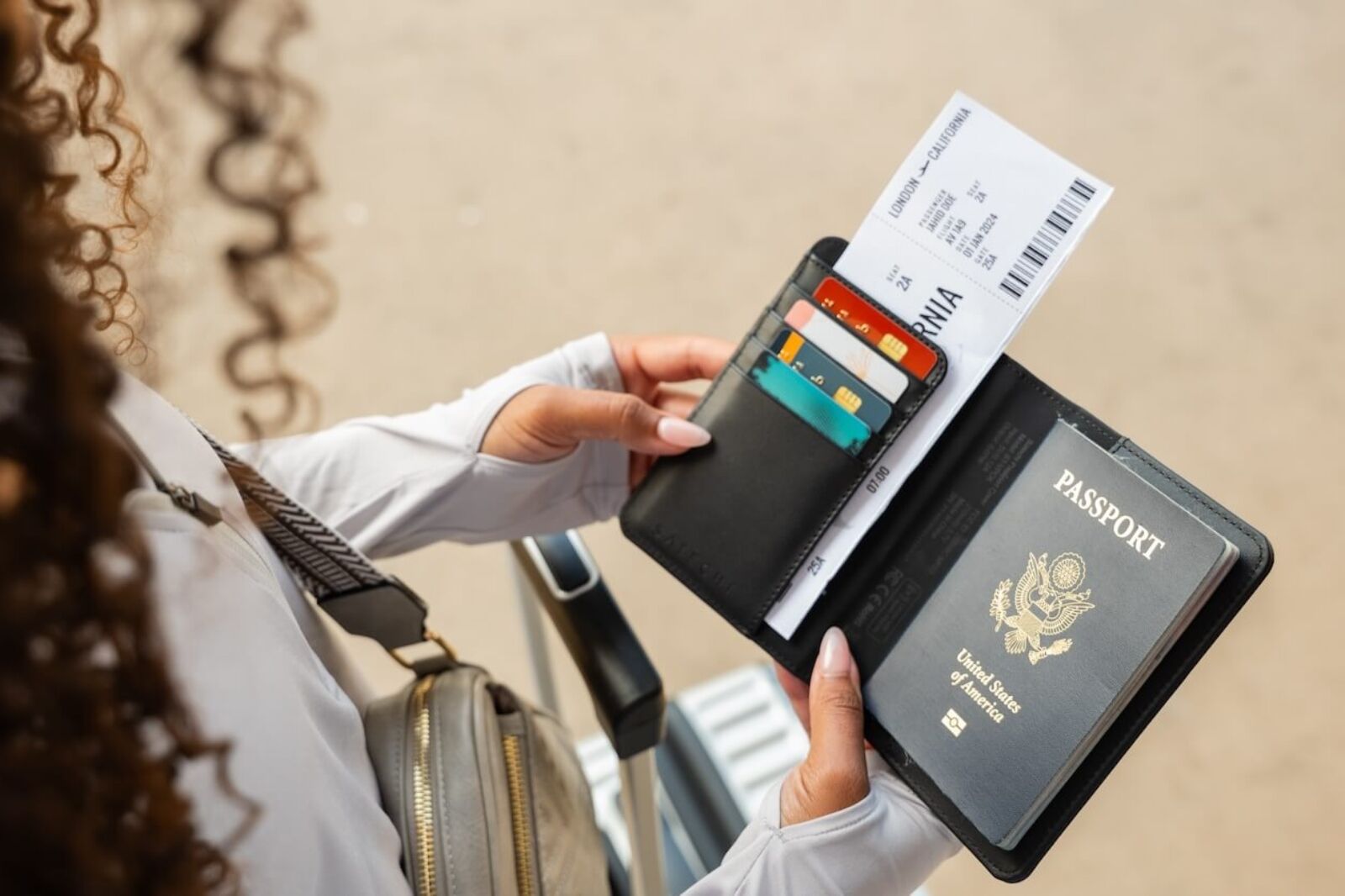 Woman holding Satechi passport cover and phone