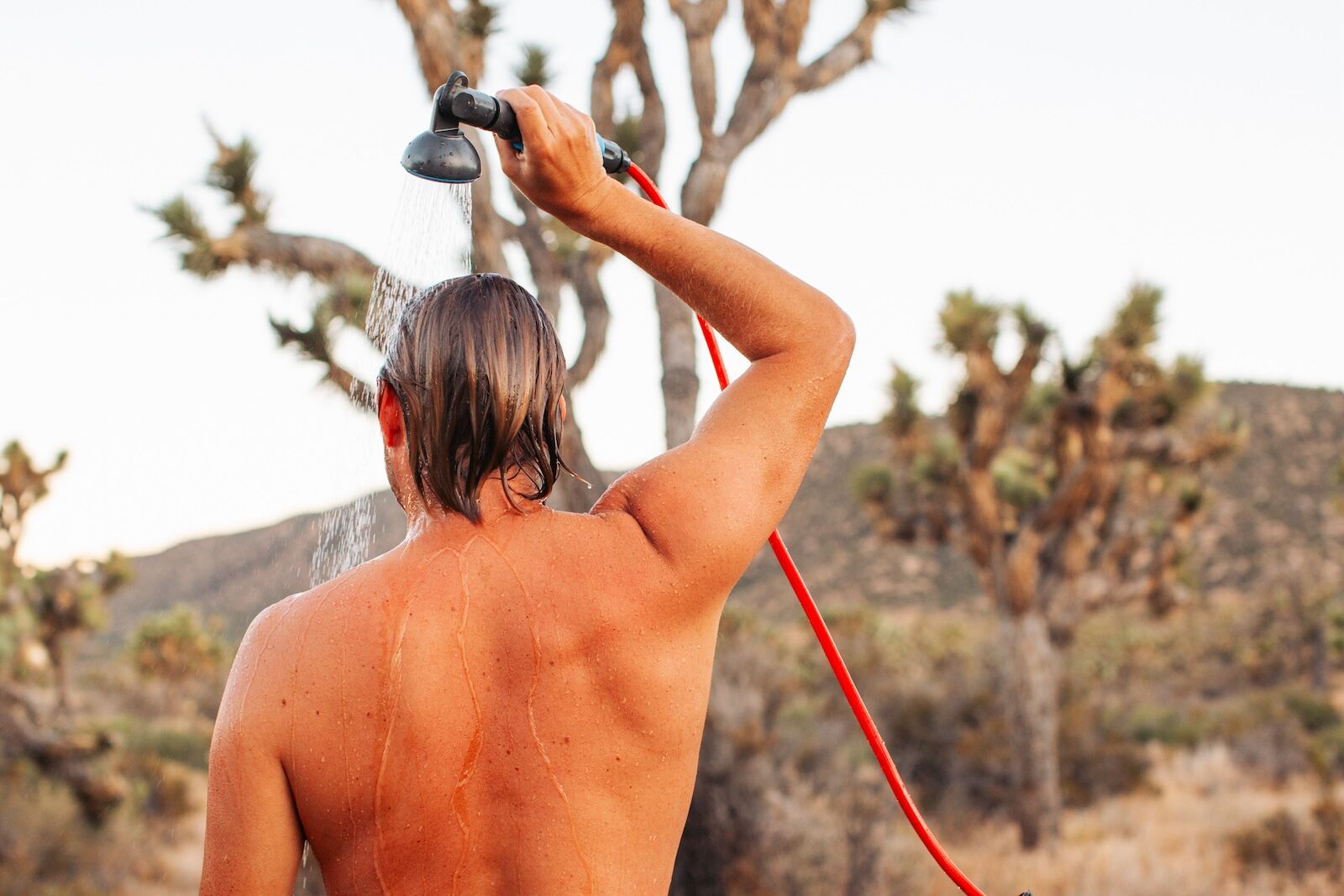 man showering with joolca hottap