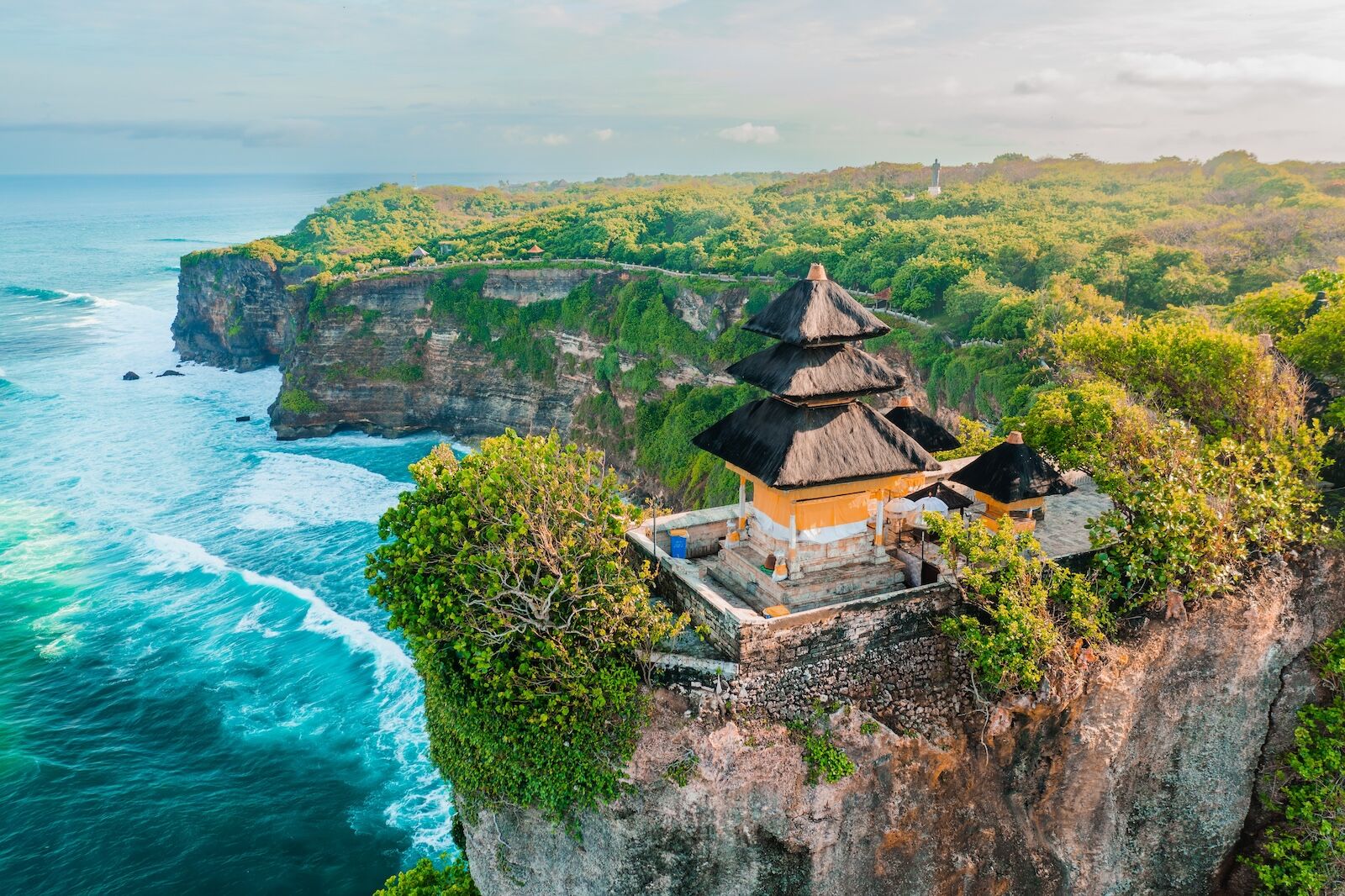 Bali's Most Iconic Landmark and popular tourist attraction Uluwatu Temple one of six key Bali temple perched on top mountain cliff on background amazi