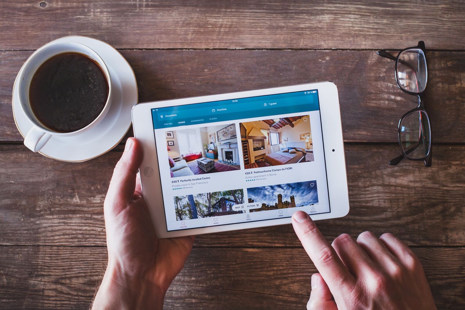 airbnb app on tablet with coffee in background