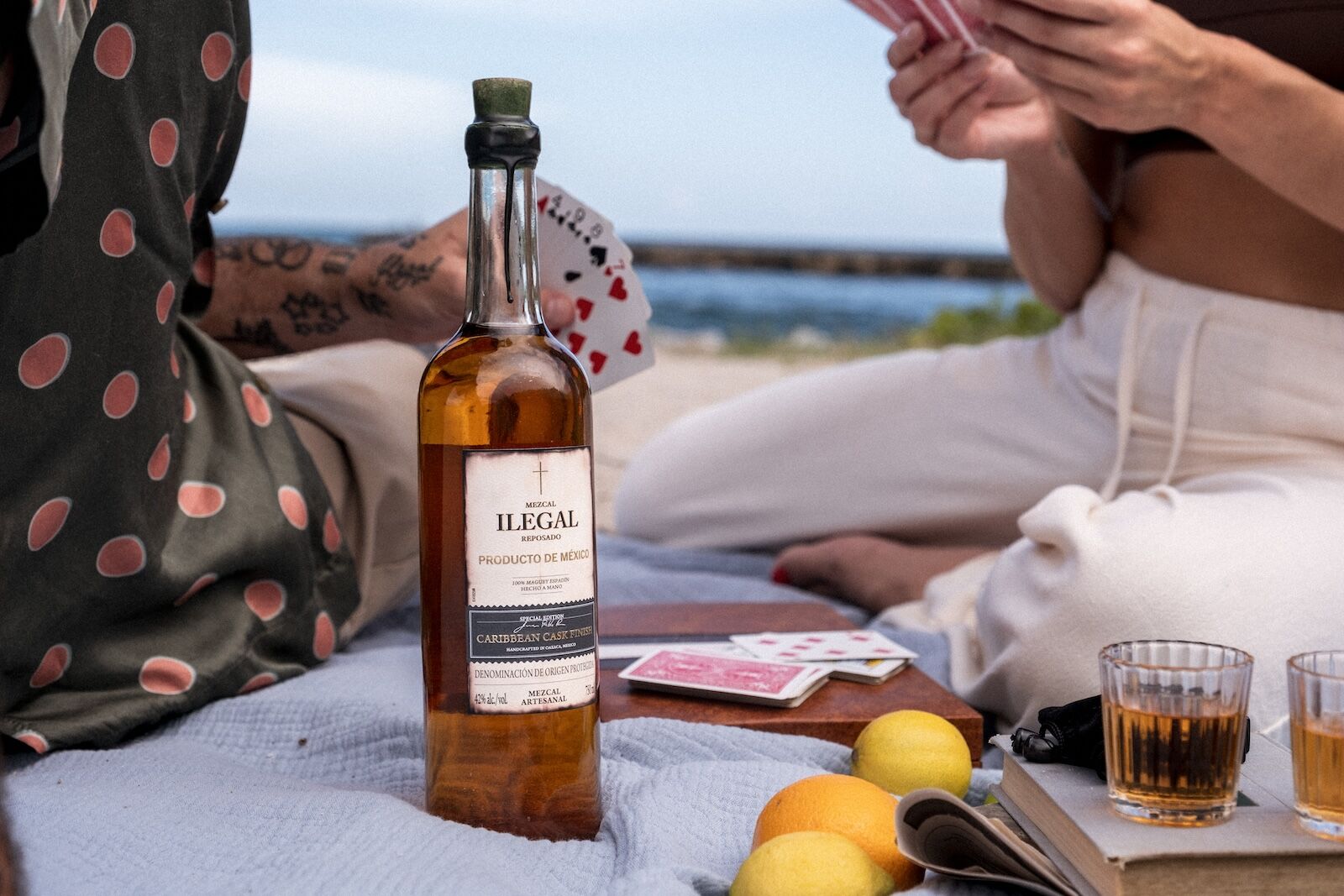 bottle of illegal mezcal on beach