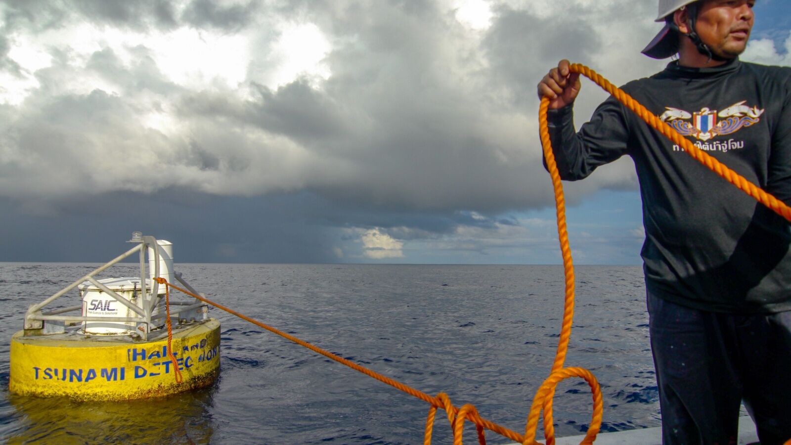 rogue wave cruise ships story - man deploying a monitoring buoy